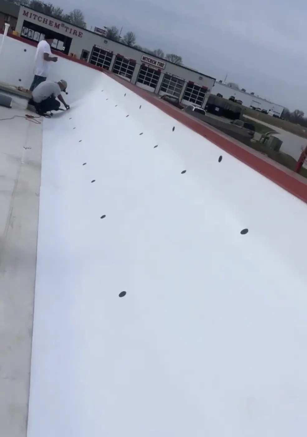 Crew detailing the edge of a TPO roof
